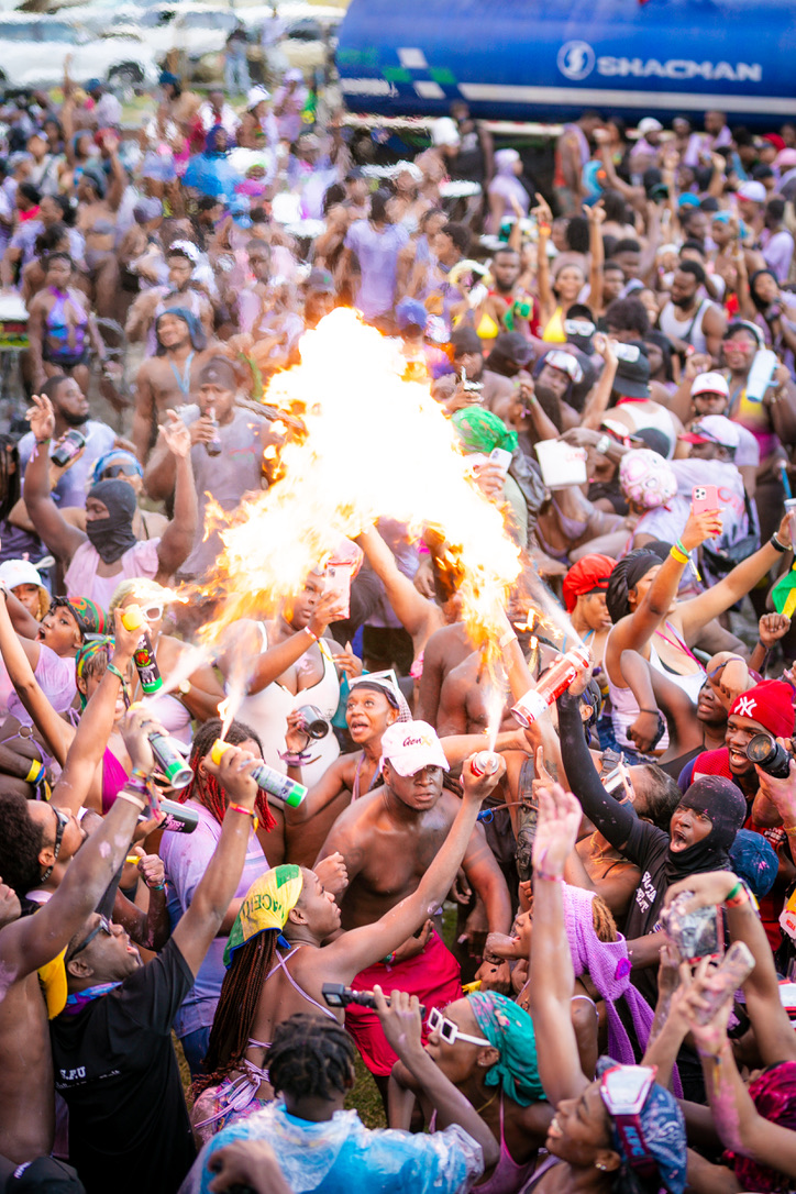 Fete crowd celebrating with flame sprays