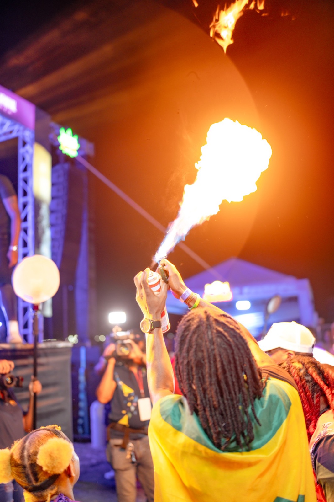 Flame spray lighting up the night crowd